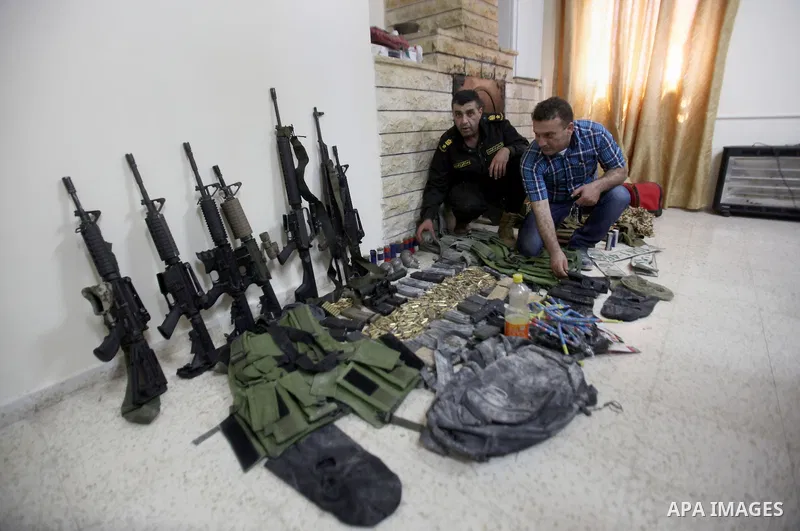Members of Palestinian security forces inspects weapons and several hand grenades for Palestinian gunmen during operation search in the old city in the west bank city of Nablus August 21, 2016. Palestinian security force...