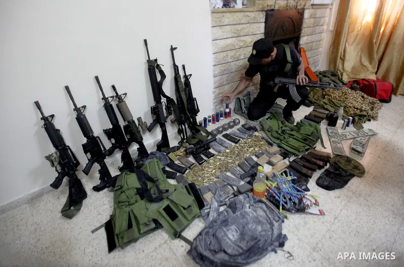 A member of Palestinian security forces inspects weapons and several hand grenades for Palestinian gunmen during operation search in the old city in the west bank city of Nablus August 21, 2016. Palestinian security forc...