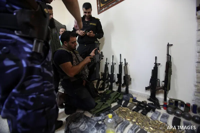 A member of Palestinian security forces inspects weapons and several hand grenades for Palestinian gunmen during operation search in the old city in the west bank city of Nablus August 21, 2016. Palestinian security forc...