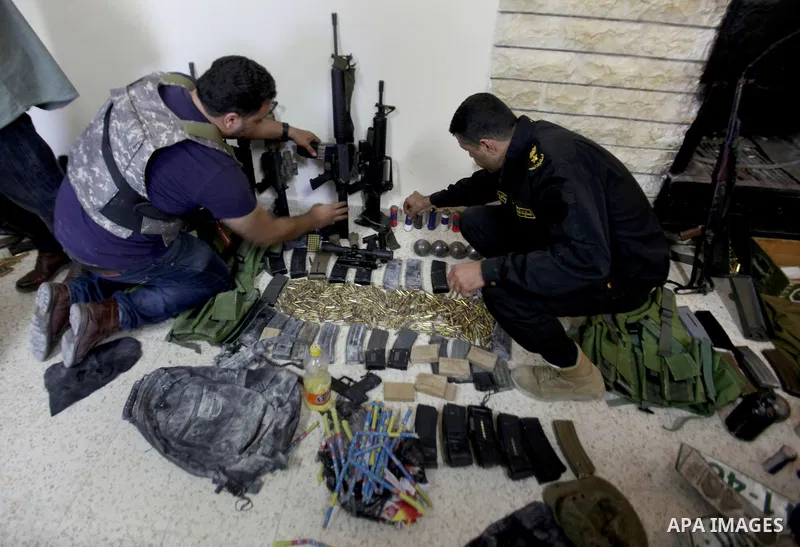 Members of Palestinian security forces inspects weapons and several hand grenades for Palestinian gunmen during operation search in the old city in the west bank city of Nablus August 21, 2016. Palestinian security force...