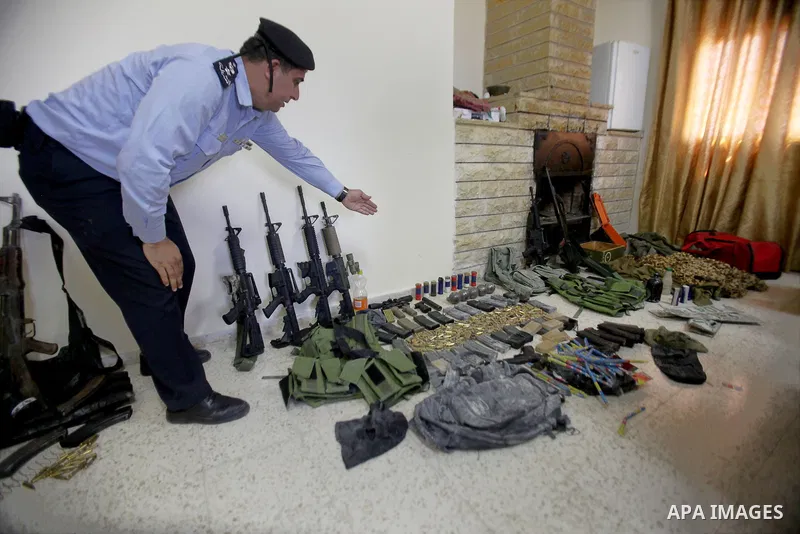 A member of Palestinian security forces inspects weapons and several hand grenades for Palestinian gunmen during operation search in the old city in the west bank city of Nablus August 21, 2016. Palestinian security forc...