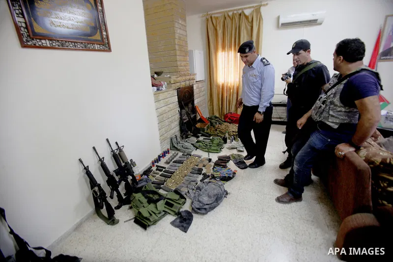 Members of Palestinian security forces inspects weapons and several hand grenades for Palestinian gunmen during operation search in the old city in the west bank city of Nablus August 21, 2016. Palestinian security force...
