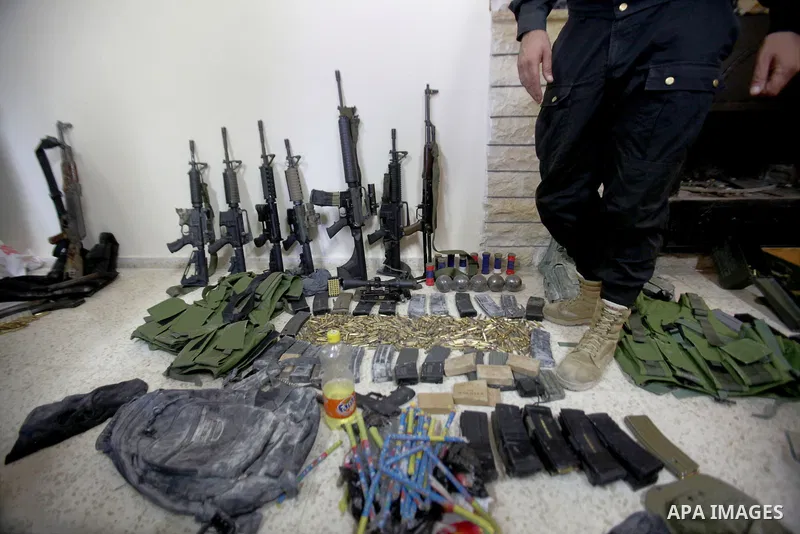 A member of Palestinian security forces inspects weapons and several hand grenades for Palestinian gunmen during operation search in the old city in the west bank city of Nablus August 21, 2016. Palestinian security forc...