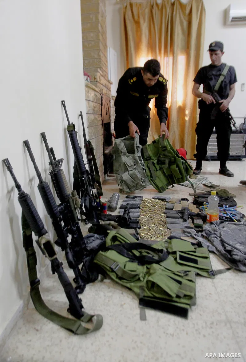 A member of Palestinian security forces inspects weapons and several hand grenades for Palestinian gunmen during operation search in the old city in the west bank city of Nablus August 21, 2016. Palestinian security forc...