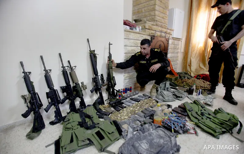 A member of Palestinian security forces inspects weapons and several hand grenades for Palestinian gunmen during operation search in the old city in the west bank city of Nablus August 21, 2016. Palestinian security forc...