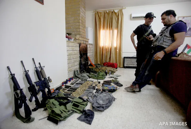 Members of Palestinian security forces inspects weapons and several hand grenades for Palestinian gunmen during operation search in the old city in the west bank city of Nablus August 21, 2016. Palestinian security force...