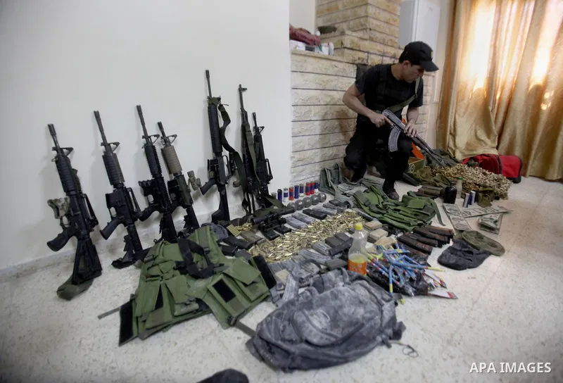 A member of Palestinian security forces inspects weapons and several hand grenades for Palestinian gunmen during operation search in the old city in the west bank city of Nablus August 21, 2016. Palestinian security forc...