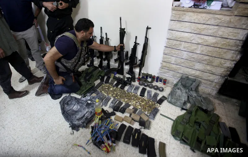 A member of Palestinian security forces inspects weapons and several hand grenades for Palestinian gunmen during operation search in the old city in the west bank city of Nablus August 21, 2016. Palestinian security forc...