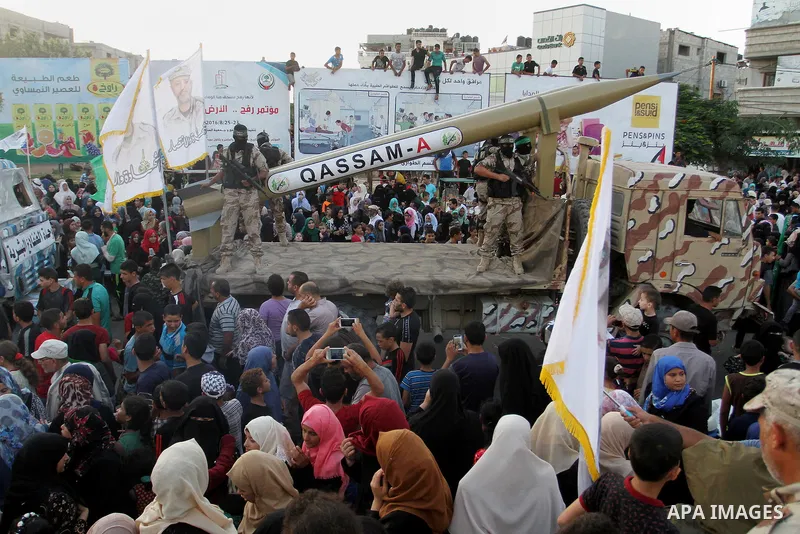 Palestinian members of al-Qassam Brigades, the armed wing of the Hamas movement, display home-made rockets during an anti-Israel military parade, in Rafah in the southern Gaza Strip August 21, 2016. Photo by Abed Rahim K...