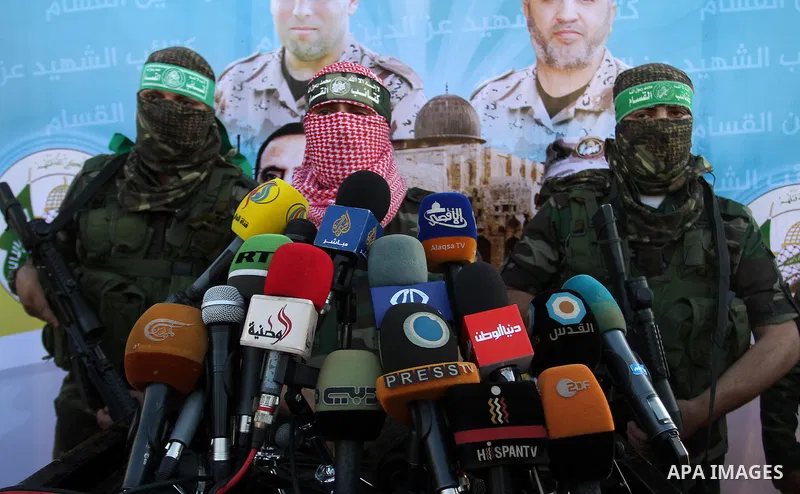Spokesman of al-Qassam Brigades, the military wing of Hamas movement, Abu Obeida speaks during an anti-Israel military parade staged by members of al-Qassam Brigades, the armed wing of the Hamas movement, in Rafah in the...