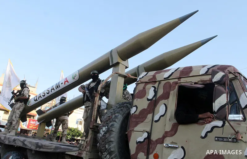 Palestinian members of al-Qassam Brigades, the armed wing of the Hamas movement, display home-made rockets during an anti-Israel military parade, in Rafah in the southern Gaza Strip August 21, 2016. Photo by Abed Rahim K...