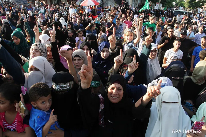Palestinians supporting Hamas chant slogans during an anti-Israel military parade staged by members of al-Qassam Brigades, the armed wing of the Hamas movement, in Rafah in the southern Gaza Strip August 21, 2016. Photo...