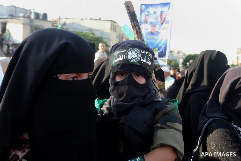 Palestinians supporting Hamas chant slogans during an anti-Israel military parade staged by members of al-Qassam Brigades, the armed wing of the Hamas movement, in Rafah in the southern Gaza Strip August 21, 2016. Photo...