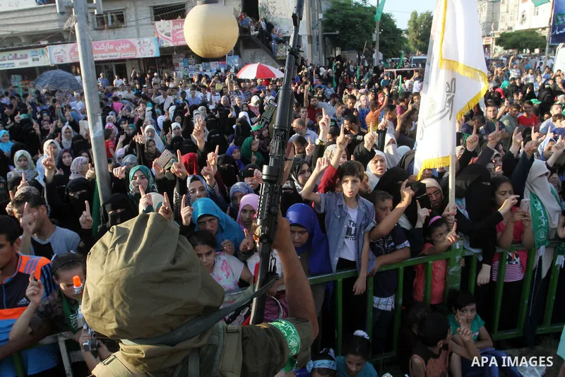 Palestinians supporting Hamas chant slogans during an anti-Israel military parade staged by members of al-Qassam Brigades, the armed wing of the Hamas movement, in Rafah in the southern Gaza Strip August 21, 2016. Photo...