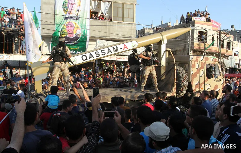 Palestinian members of al-Qassam Brigades, the armed wing of the Hamas movement, display home-made rockets during an anti-Israel military parade, in Rafah in the southern Gaza Strip August 21, 2016. Photo by Abed Rahim K...