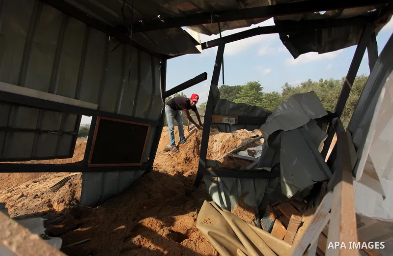 A Palestinian man of the Islamic Jihad movement inspects the rubble of a makeshift dwelling on August 22, 2016 in Beit Lahia in the northern Gaza Strip, following an Israeli airstrike the day before that targeted Hamas p...