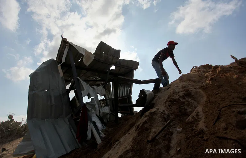A Palestinian man of the Islamic Jihad movement inspects the rubble of a makeshift dwelling on August 22, 2016 in Beit Lahia in the northern Gaza Strip, following an Israeli airstrike the day before that targeted Hamas p...