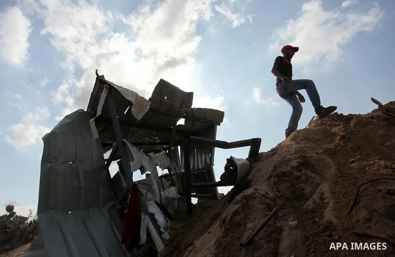 A Palestinian man of the Islamic Jihad movement inspects the rubble of a makeshift dwelling on August 22, 2016 in Beit Lahia in the northern Gaza Strip, following an Israeli airstrike the day before that targeted Hamas p...