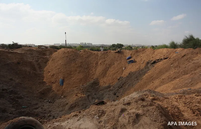Palestinian security men arrive to inspect a crater on August 22, 2016 in Beit Lahia in the northern Gaza Strip, following an Israeli airstrike the day before that targeted Hamas positions in the Gaza Strip in response t...