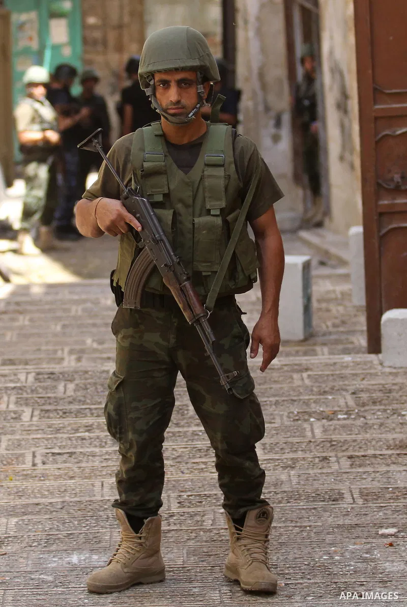 Members of the Palestinian security forces patrol in the West Bank city of Nablus on August 22, 2016 during ongoing clashes between the security forces and Palestinian gunmen. Palestinian security forces detained two Nab...