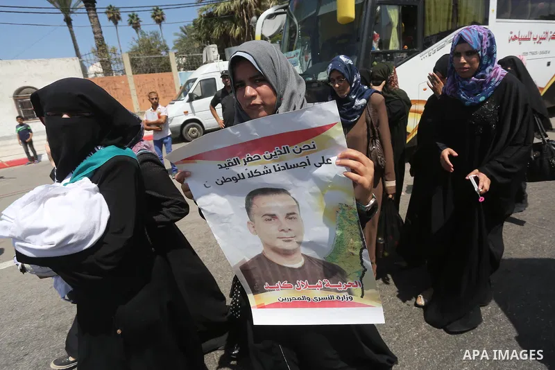 Palestinians hold posters against administrative detention and in support of Palestinian prisoner Bilal Kayed, who has been fasting for almost two months over his detention without trial, in Gaza city on Aug. 23, 2016. P...