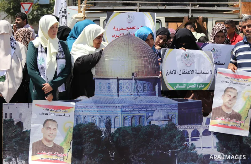 Palestinians hold posters against administrative detention and in support of Palestinian prisoner Bilal Kayed, who has been fasting for almost two months over his detention without trial, in Gaza city on Aug. 23, 2016. P...