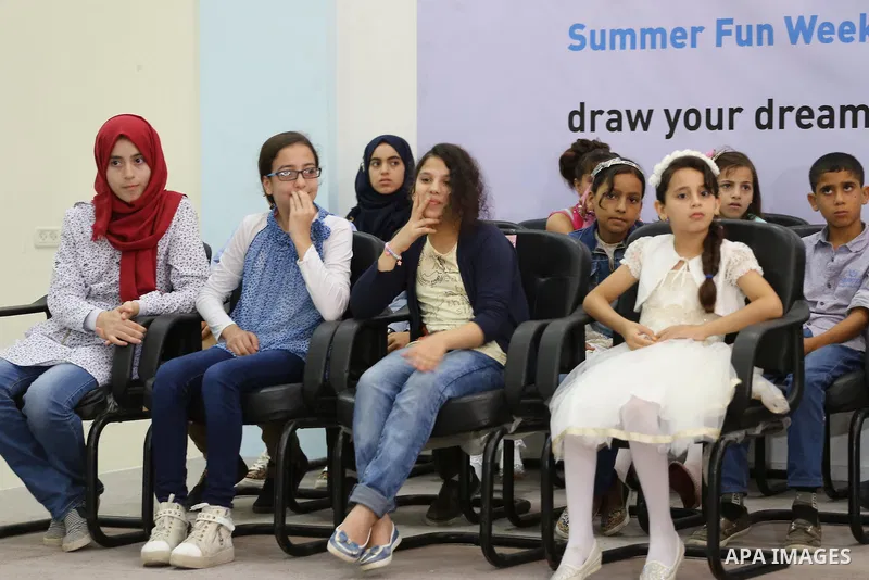 Palestinians attend the art exhibition "draw your dream for Gaza 2020", in Gaza city on Aug. 23, 2016. Photo by Mohammed Asad