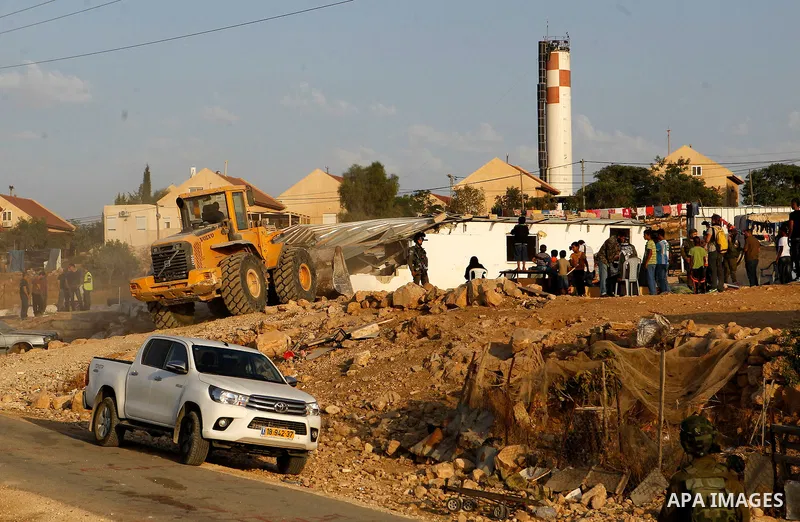Israeli troops stand guard as bulldozers demolish houses near the West Bank village of Um AlKhair, south of Hebron August 24, 2016. Photo by Wisam Hashlamoun
