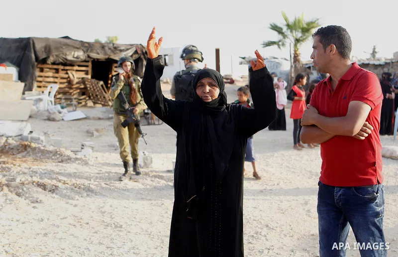 Palestinian Bedouins scuffle with Israeli soldiers after Israeli troops demolished their house near the West Bank village of Um AlKhair, south of Hebron August 24, 2016. Photo by Wisam Hashlamoun