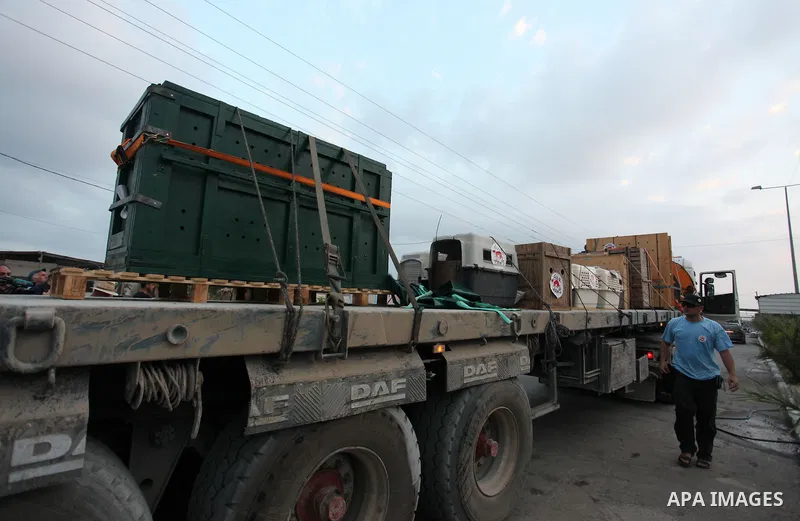 Members of the international animal welfare charity "Four Paws" transport animals across the Erez border crossing into Israel after evacuating them from the zoo in Khan Yunis in the southern Gaza Strip on August 24, 2016...