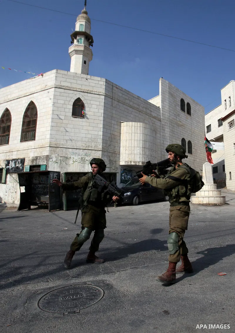 Israeli soldiers conduct a search near the scene where Palestinian Sari Abu Ghrab was shot dead by Israeli troops near the West Bank village of Madama near Nablus August 24, 2016. An Israeli army statement said Israeli f...