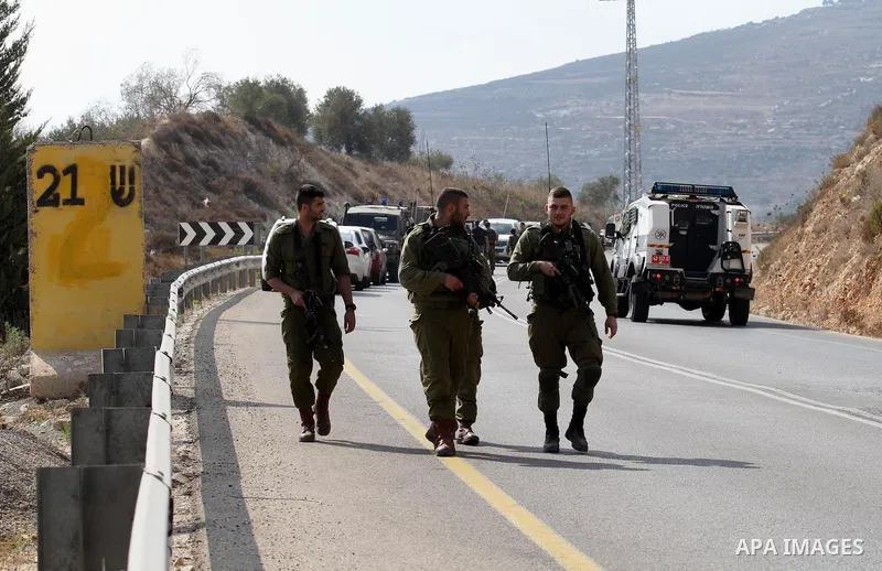 Israeli security forces gather at the scene where Palestinian Sari Abu Ghrab was shot dead by Israeli troops near the West Bank village of Madama near Nablus August 24, 2016. An Israeli army statement said Israeli forces...