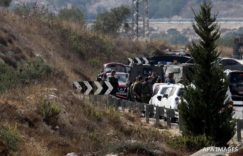 Israeli security forces gather at the scene where Palestinian Sari Abu Ghrab was shot dead by Israeli troops near the West Bank village of Madama near Nablus August 24, 2016. An Israeli army statement said Israeli forces...