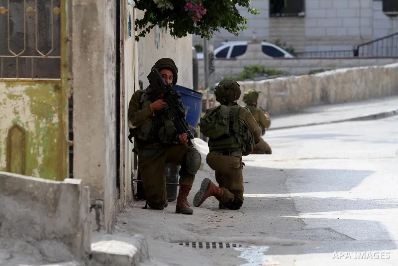 Israeli soldiers conduct a search near the scene where Palestinian Sari Abu Ghrab was shot dead by Israeli troops near the West Bank village of Madama near Nablus August 24, 2016. An Israeli army statement said Israeli f...