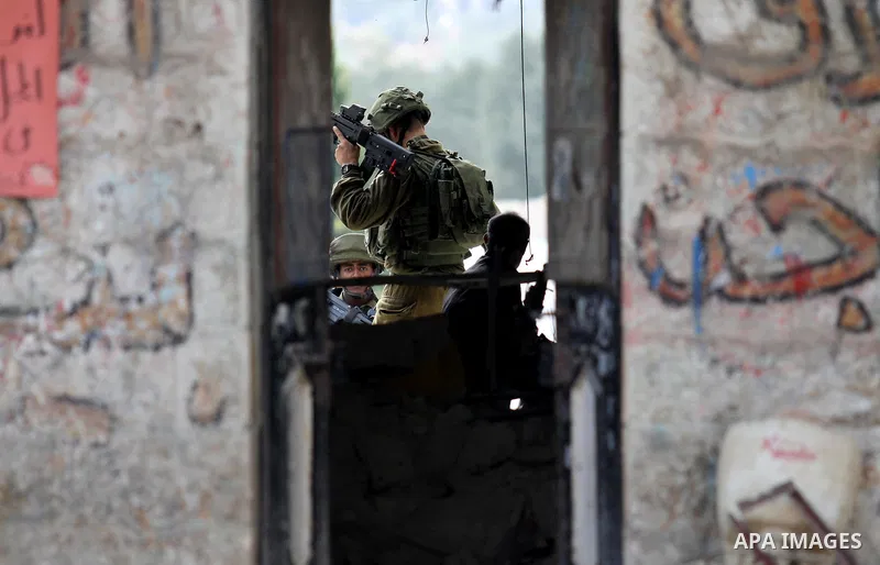 An Israeli soldier conducts a search near the scene where Palestinian Sari Abu Ghrab was shot dead by Israeli troops near the West Bank village of Madama near Nablus August 24, 2016. An Israeli army statement said Israel...