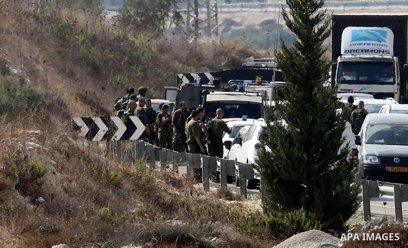 Israeli security forces gather at the scene where Palestinian Sari Abu Ghrab was shot dead by Israeli troops near the West Bank village of Madama near Nablus August 24, 2016. An Israeli army statement said Israeli forces...