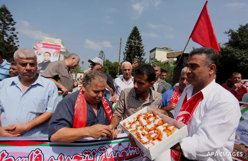 Supporters of the Popular Front for the Liberation of Palestine (PFLP) take part in a celebration of Bilal Kayed, in Gaza city on August 25, 2016. Palestinian prisoner Bilal Kayid has suspended his hunger strike after sp...