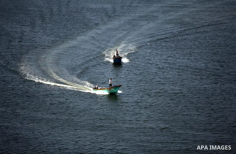 Palestinian fishermen ride their fishing boats at Gaza's seaport of Gaza City, on Aug. 25, 2016. Israeli naval forces wound Palestinian fisherman after opening fire on boats in the northern Gaza Strip. Photo by Ashraf Am...