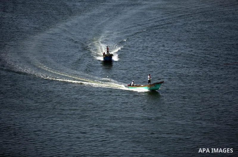Palestinian fishermen ride their fishing boats at Gaza's seaport of Gaza City, on Aug. 25, 2016. Israeli naval forces wound Palestinian fisherman after opening fire on boats in the northern Gaza Strip. Photo by Ashraf Am...