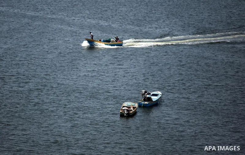 Palestinian fishermen ride their fishing boats at Gaza's seaport of Gaza City, on Aug. 25, 2016. Israeli naval forces wound Palestinian fisherman after opening fire on boats in the northern Gaza Strip. Photo by Ashraf Am...