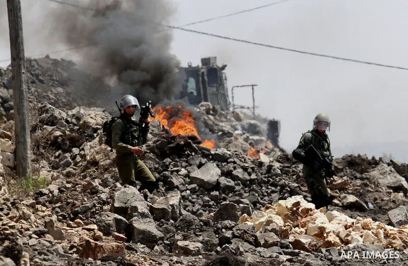 Israeli security forces take position during clashes with Palestinian protesters following a weekly demonstration against the expropriation of Palestinian land by Israel on August 26, 2016, in the village of Kfar Qaddum,...
