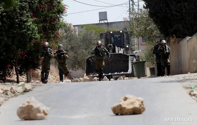Israeli security forces take position during clashes with Palestinian protesters following a weekly demonstration against the expropriation of Palestinian land by Israel on August 26, 2016, in the village of Kfar Qaddum,...