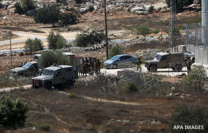 Israeli troops gather at the scene where a Palestinian was shot and killed by Israeli forces in the West Bank village of Silwad near Ramallah August 26, 2016. Silwad, close to the Jewish settlement of Ofra, is under cons...