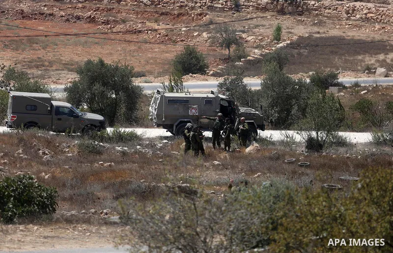 Israeli troops gather at the scene where a Palestinian was shot and killed by Israeli forces in the West Bank village of Silwad near Ramallah August 26, 2016. Silwad, close to the Jewish settlement of Ofra, is under cons...