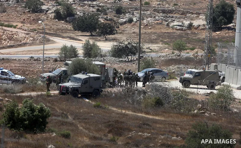 Israeli troops gather at the scene where a Palestinian was shot and killed by Israeli forces in the West Bank village of Silwad near Ramallah August 26, 2016. Silwad, close to the Jewish settlement of Ofra, is under cons...