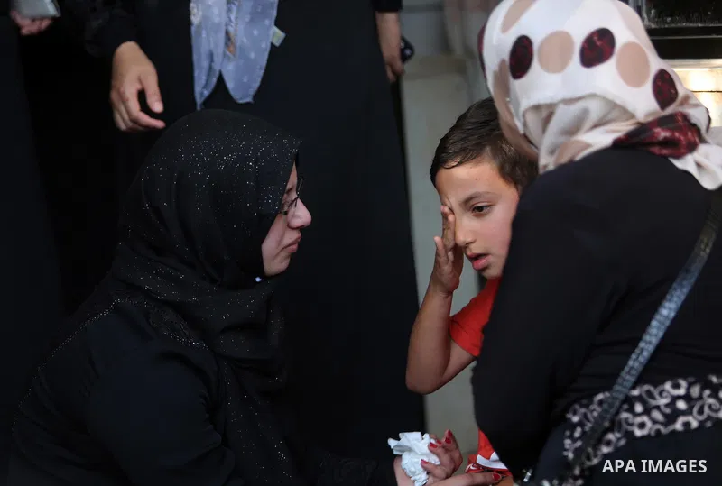 Relatives of Palestinian man Eyad Hamed who was shot and killed by Israeli forces on Friday, mourn around his body during his funeral in the West Bank village of Silwad near Ramallah August 26, 2016. Photo by Shadi Hatem