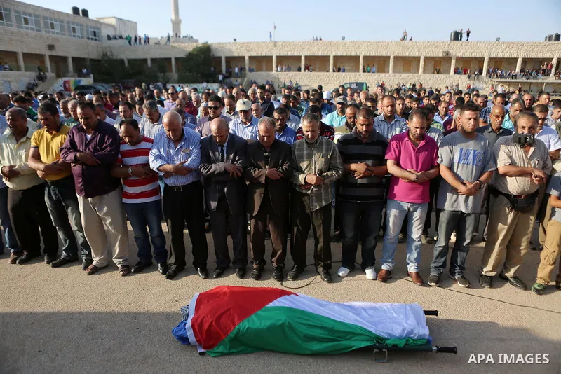 Mourners pray in front of the body of Palestinian man Eyad Hamed, who was shot and killed by Israeli forces on Friday, during his funeral in the West Bank village of Silwad near Ramallah August 26, 2016. Photo by Shadi H...