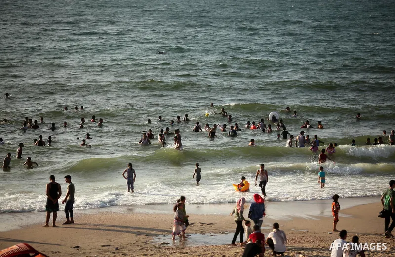 Palestinian children enjoy a day at the beach in Deir Al Balah in the center of Gaza strip at the last Friday of summer holiday, on Aug. 26, 2016. Photo by Ashraf Amra