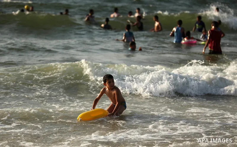 Palestinian children enjoy a day at the beach in Deir Al Balah in the center of Gaza strip at the last Friday of summer holiday, on Aug. 26, 2016. Photo by Ashraf Amra
