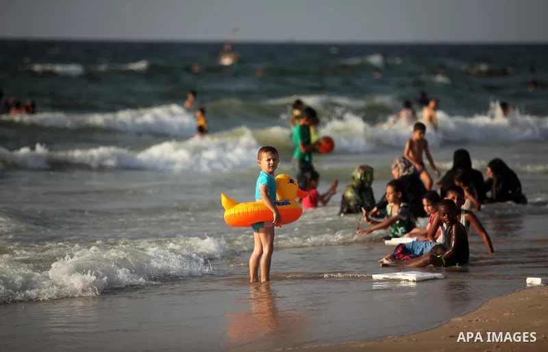 Palestinian children enjoy a day at the beach in Deir Al Balah in the center of Gaza strip at the last Friday of summer holiday, on Aug. 26, 2016. Photo by Ashraf Amra